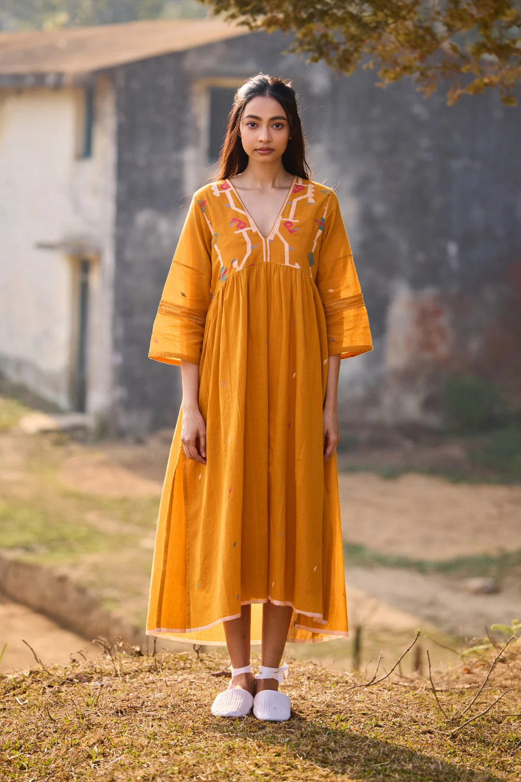 Sarron Ushnota Dress, mustard yellow cotton Jamdani V-neck dress with a geometric yoke motif and Kantha-worked sleeves.