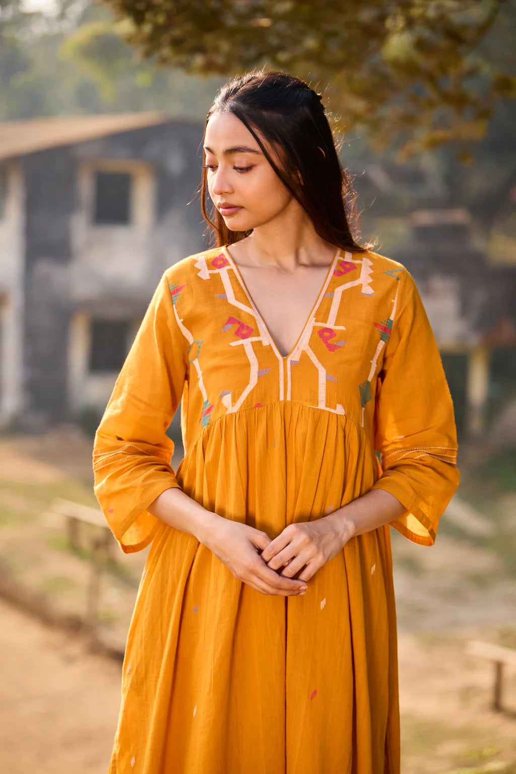 Sarron Ushnota Dress, mustard yellow cotton Jamdani V-neck dress with a geometric yoke motif and Kantha-worked sleeves.