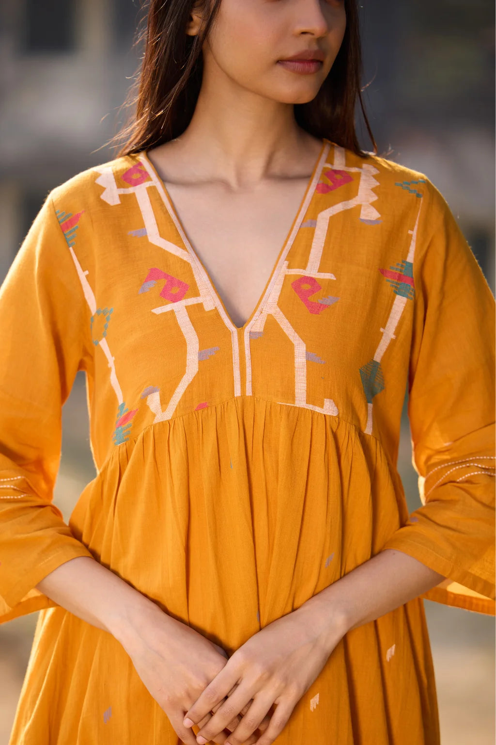 Sarron Ushnota Dress, mustard yellow cotton Jamdani V-neck dress with a geometric yoke motif and Kantha-worked sleeves.