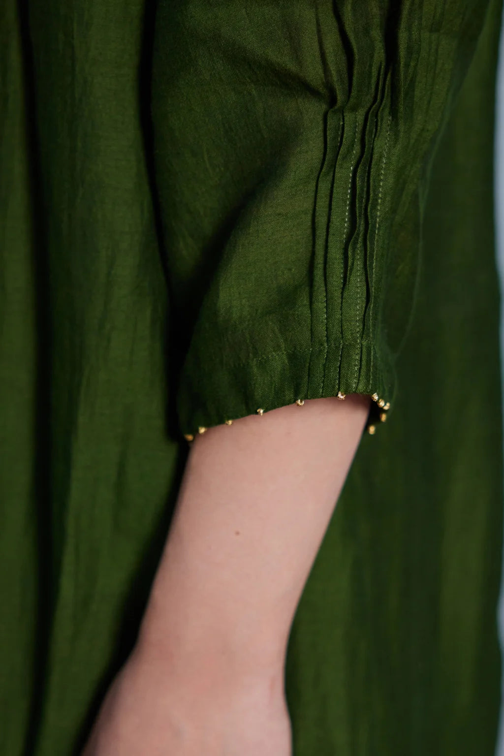 Sarron Vrinda Dress, dark olive silk-cotton Jamdani dress with a large floral placement buta.