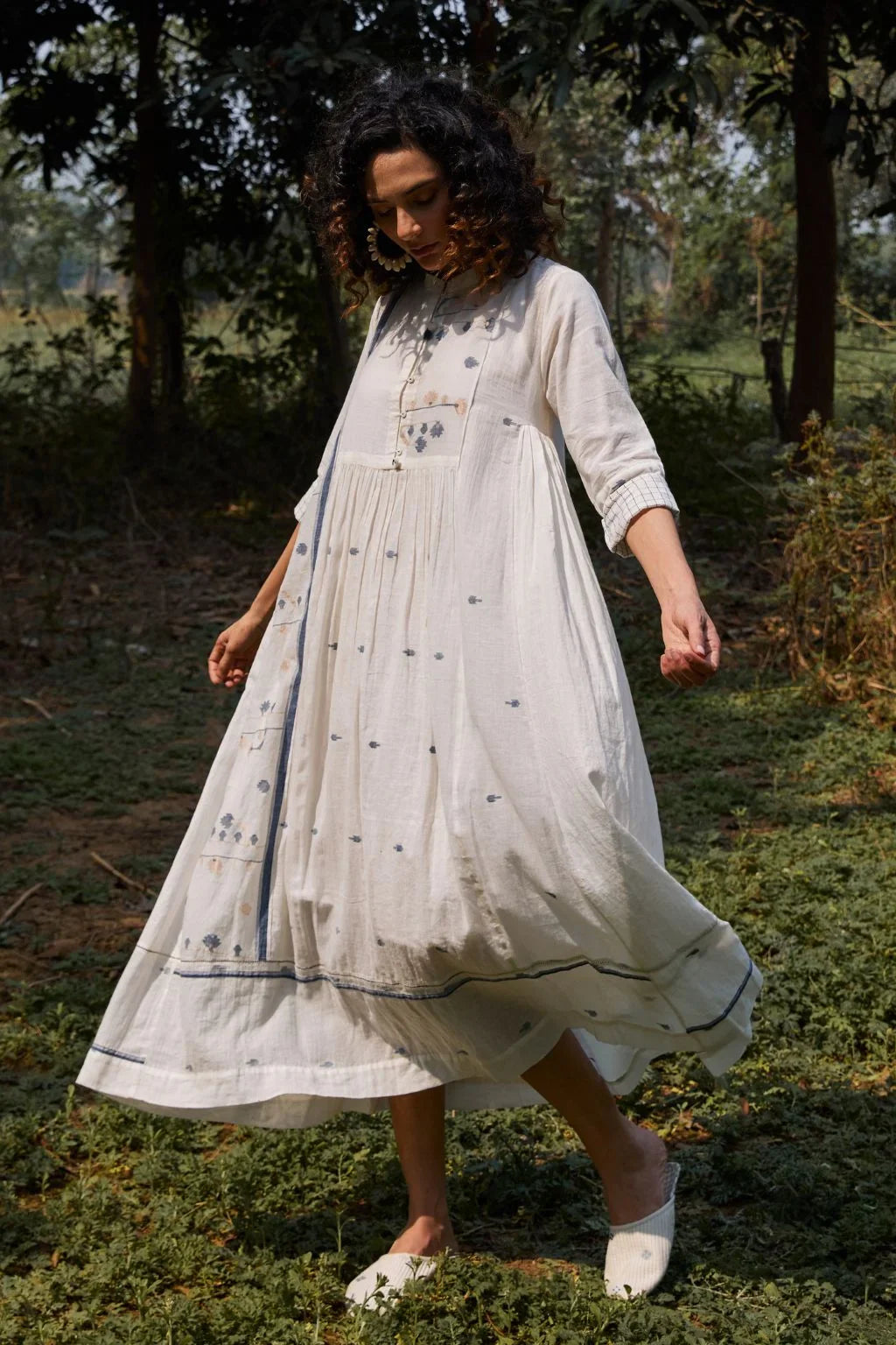 Sarron Yashvi Dress, white cotton Jamdani dress with handwoven blue motifs and a mandarin collar.
