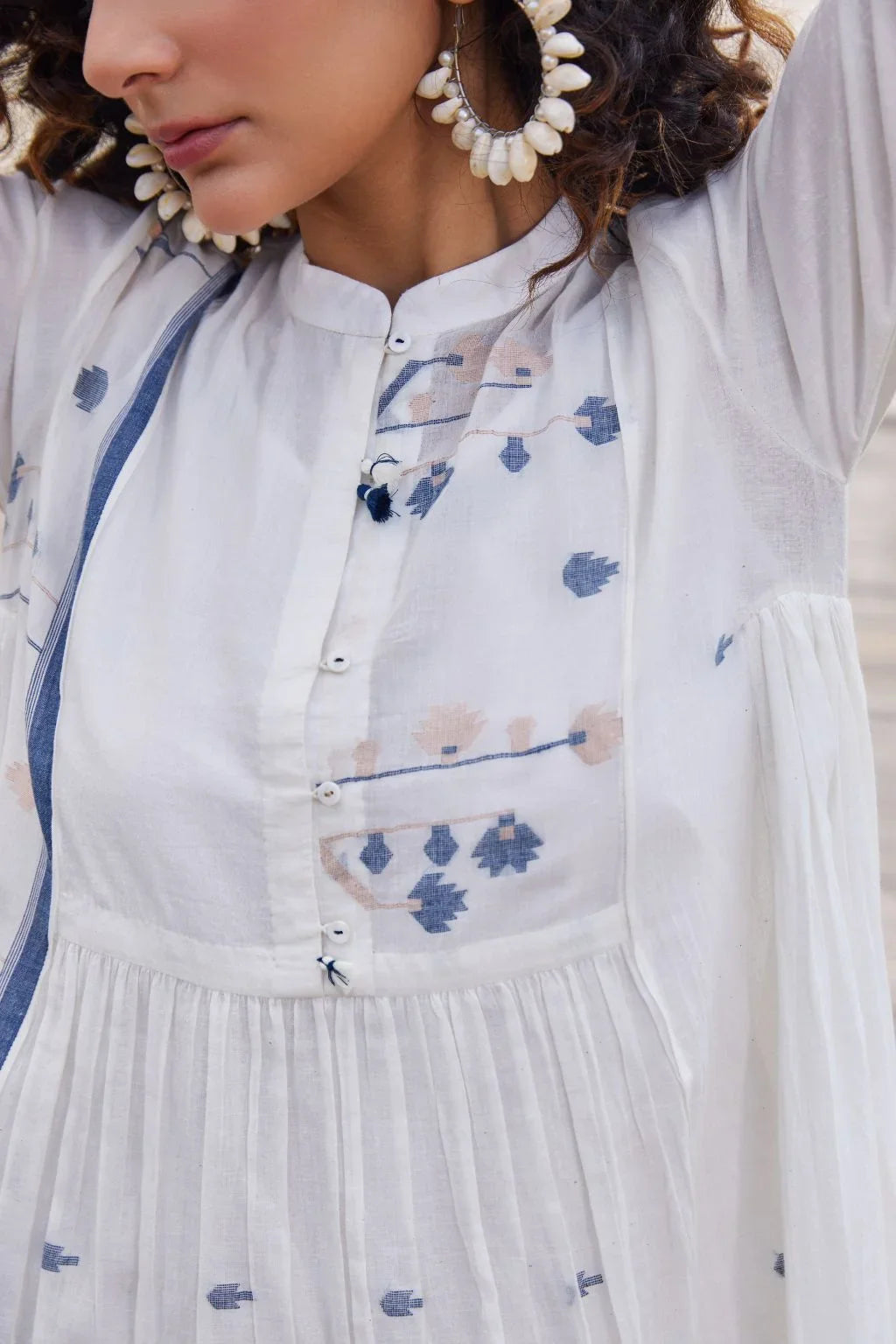 Sarron Yashvi Dress, white cotton Jamdani dress with handwoven blue motifs and a mandarin collar.